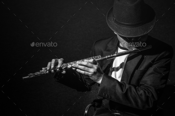 Flute music playing flutist musician performer on black background, musical  instrument Stock Photo by thananit_s