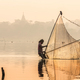 Fishermen fishing by traditional net in the river near U-Bein