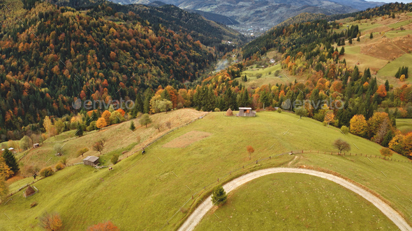Sun mountain road aerial. Autumn nobody nature landscape. Village at mist haze. Countryside forest - Stock Photo - Images