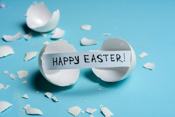 Cracked egg on light blue background Stock Photo by molenira | PhotoDune