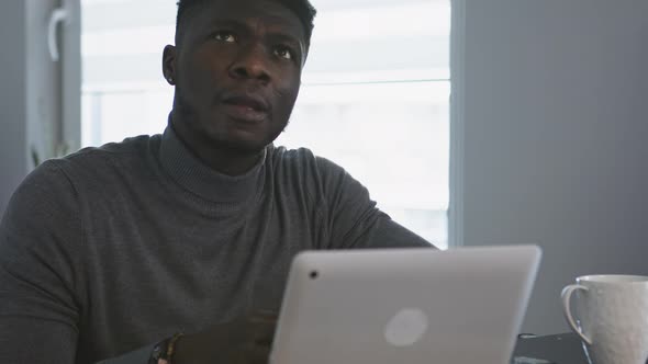 African American Black Man Working on the Laptop in His Appartment alt