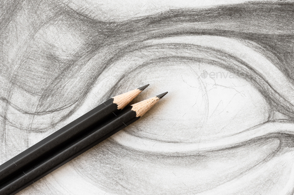 two graphite pencils on drawing of David\'s eye