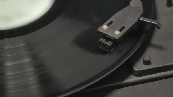 Detail of vintage record player with spinning vinyl. Shallow focus alt