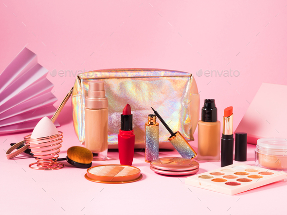 Make up cosmetics products on pink and beauty bag