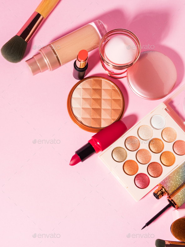 Different make up beauty cosmetics products on pink