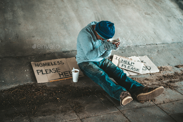 Beggars sitting under a bridge with cups have money.