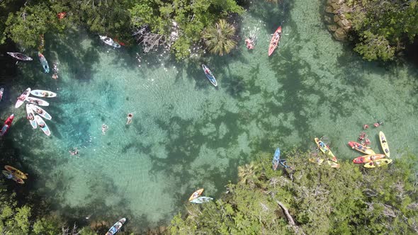 Three sisters spring near Crystal River, Florida. Kayakers and swimmers, aerial top down view alt