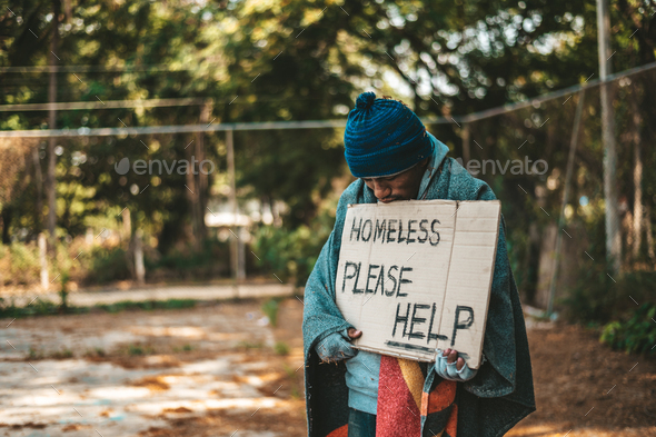 Beggars stand on the street with homeless messages please help.