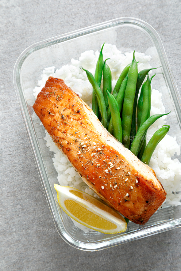 Lunch box containers with grilled salmon fish fillet, rice and green beans