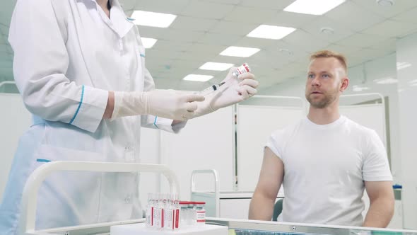 Doctor is Injecting a Patient with Coronavirus Vaccine alt