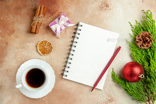 top view empty open notepad with green branch and tea on light-white background copybook new year