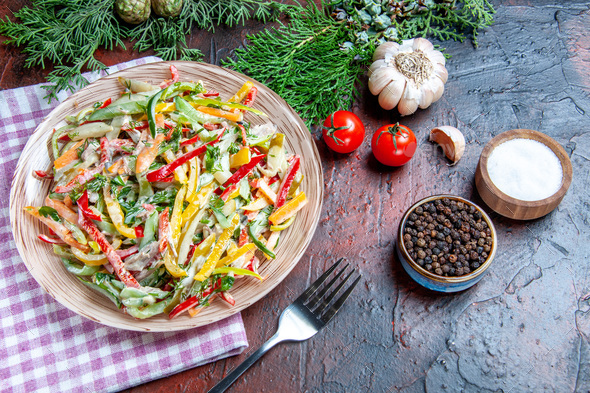 https://s3.envato.com/files/326499112/bottom%20view%20(vegetable%20salad)%20on%20plate%20on%20tablecloth%20fork%20salt%20and%20black%20pepper%20pine%20branches%20garlic%20tomatoes%20on%20dark%20red%20table.jpg