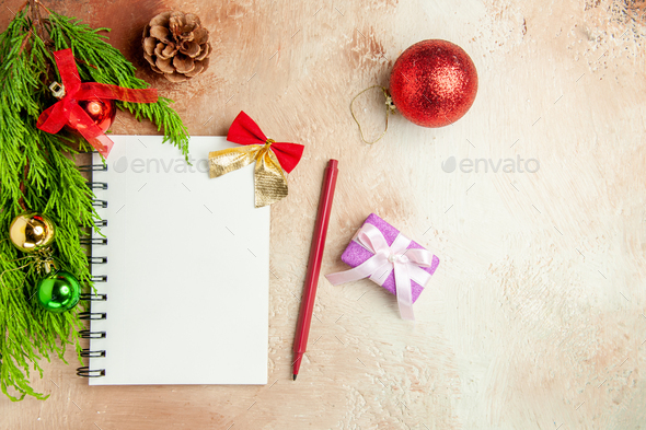 top view empty open notepad with green branch and toys on light-white background copybook new year