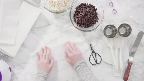 Flat lay. Step by step. Ingredients to prepare chocolate dipped strawberries on a marble surface. alt