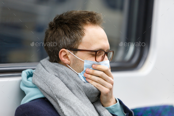 Sick man wear face protective mask in subway train during covid-19 corona pandemic.