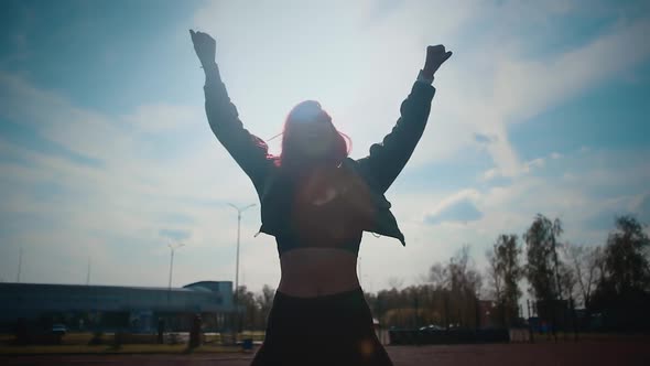 Silhouette of a girl on a light background, young beautiful woman dancer alt