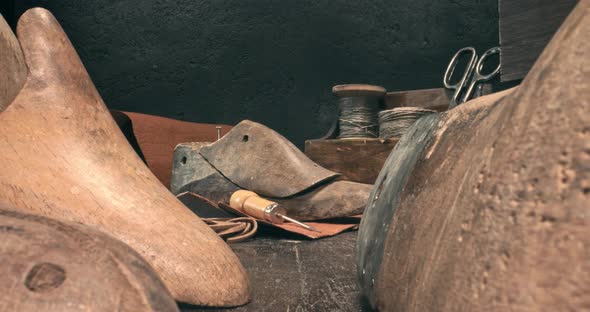 Small cobbler workplace with tools, strap, leather and rules. alt