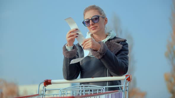 Buyer Checks Paper Receipt On Shopping Supermarket. Customer Receipt Bill Expensive Total. alt