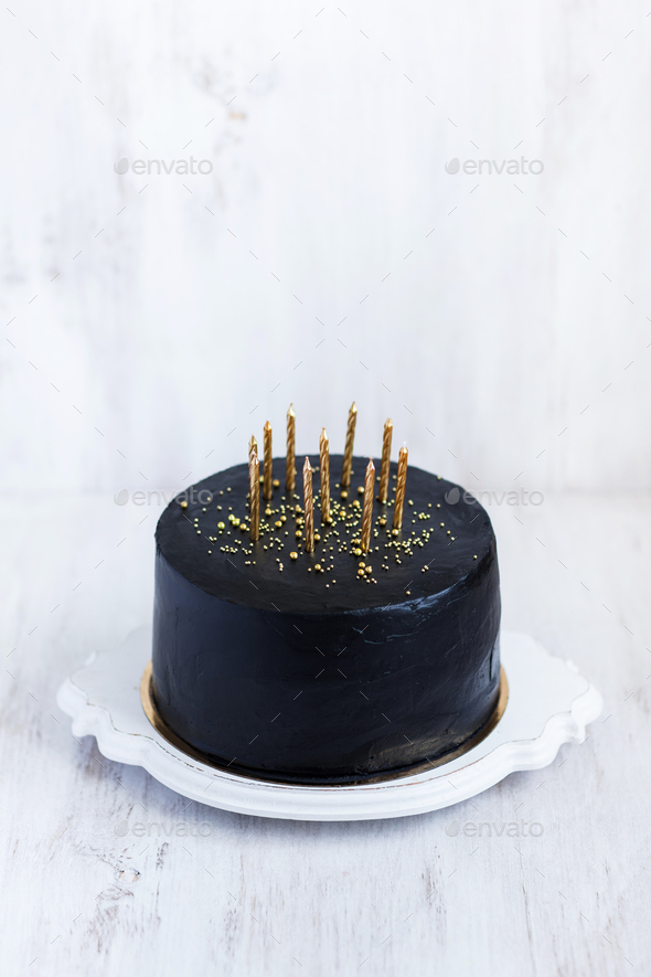 Black birthday cake with golden candles on white background Stock Photo by  olegbreslavtsev