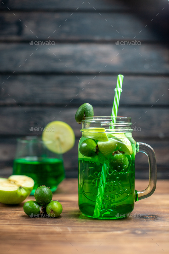 front view green feijoa juice inside can with green apples on the wooden desk bar fruit color drink