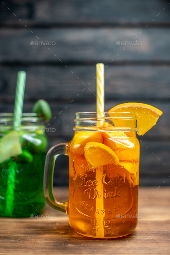 front view different fresh juices inside cans on brown wooden desk drink bar fruit photo color