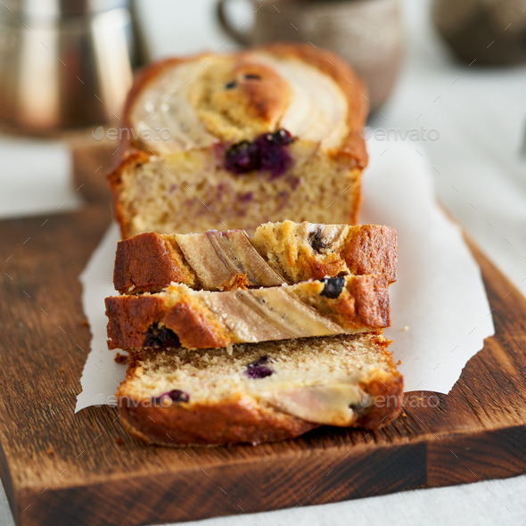 Banana bread, slice of cake with banana and blueberries. Morning breakfast with coffee - Stock Photo - Images