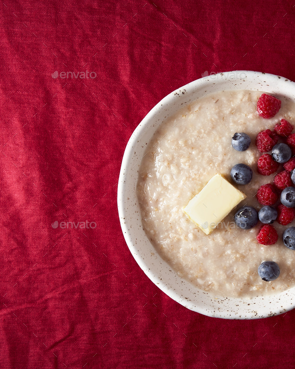 Part of oatmeal porridge with blueberry, bilberry. Close up breakfast in white bowl with fresh - Stock Photo - Images