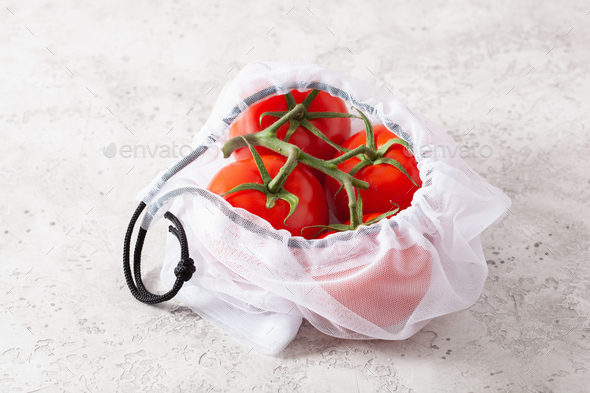 tomato vegetables in reusable mesh nylon bag, plastic free zero waste concept