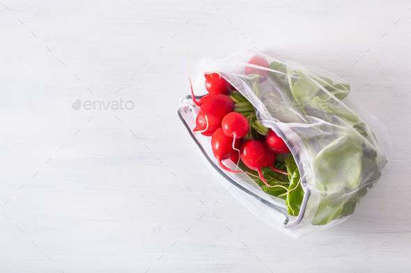 radish vegetable in reusable mesh nylon bag, plastic free zero waste concept