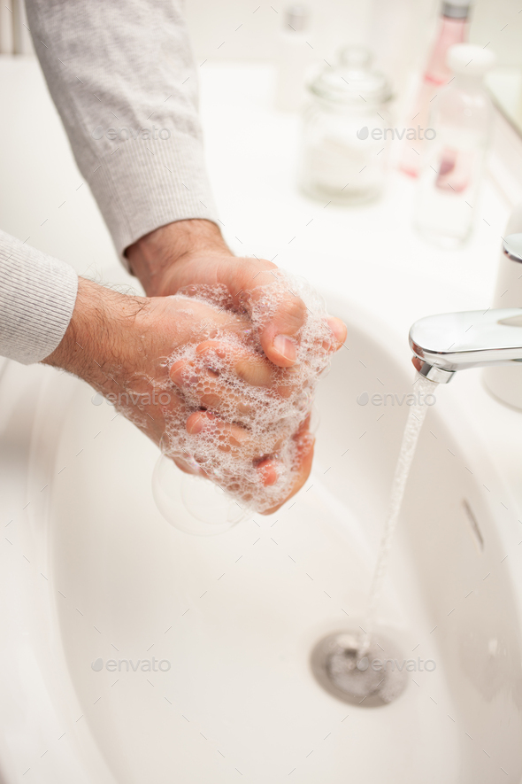 man washing hands with soap at home. coronavirus prevention hand hygiene