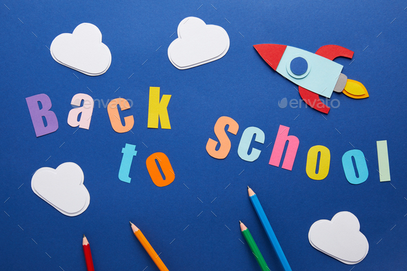 Top View Of Back To School Lettering With Pencils Clouds And Rocket On Blue Background Stock Photo By Lightfieldstudios