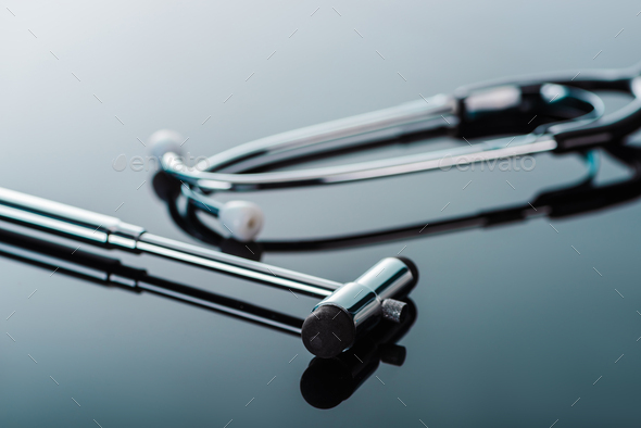 selective focus of reflex hammer and stethoscope on glass surface
