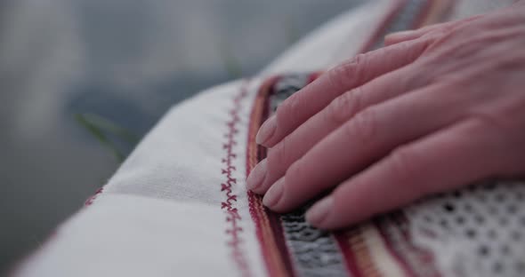 Ukrainian Embroidered Shirt Fingers Touch the Embroidered Canvas 0 alt