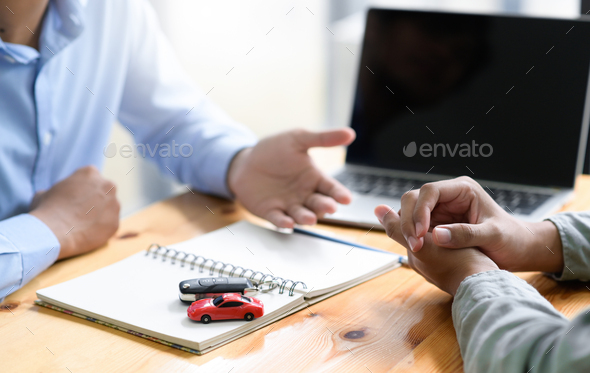 Insurance broker is recommending auto accident insurance to clients. - Stock Photo - Images