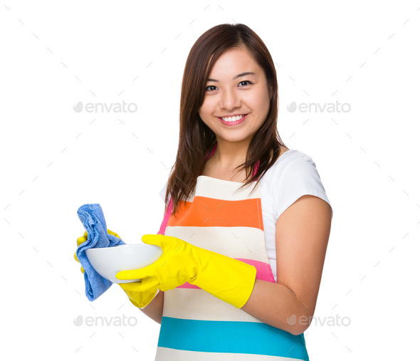 Young Housewife wash the dish