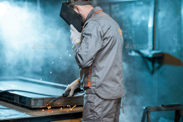Welder working with metal at the workshop