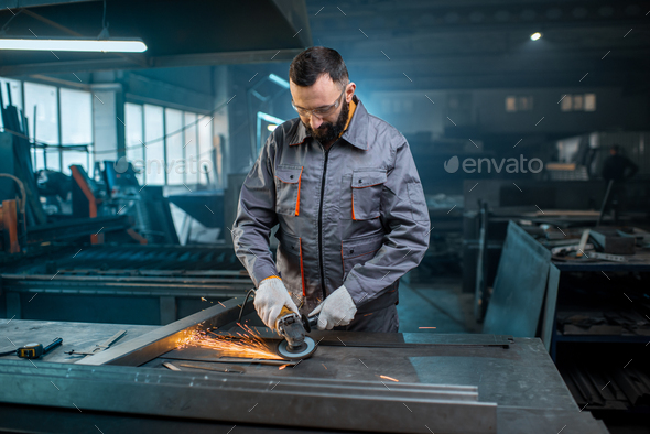 Metal industry worker at factory in work wear