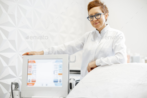Cosmetologist with Ultrasound lifting device in beauty clinic