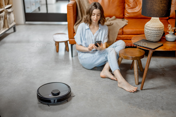 Robotic vacuum cleaner cleaning the room at home