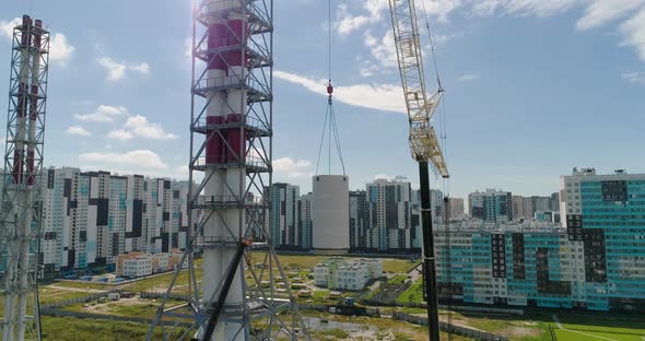 Chimney Pipe Construction, the Crane Lifts the Pipe Segment. Aerial Shot