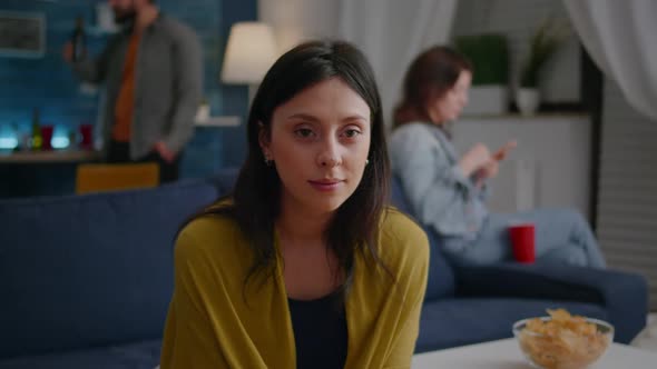 Close Up of Beautiful Woman Looking Into Camera While Sitting on Sofa During Night Party alt