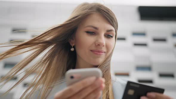 Attractive Woman is Entering Credit Card Number for Online Shopping Using Mobile alt