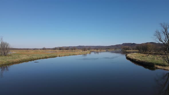 Wide landscape view of waterways in Wisconsin in autumn. Calm water. Reflections from the sun