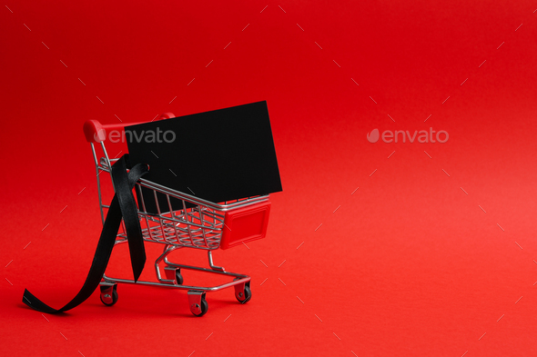 Shop trolley with tag on red background