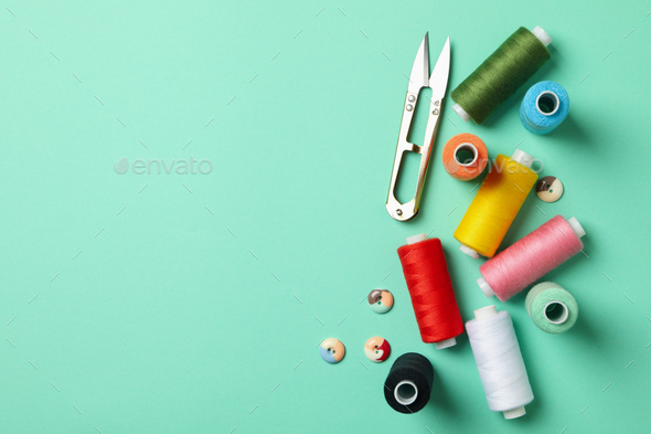 Sewing supplies on mint background, top view Stock Photo by AtlasComposer