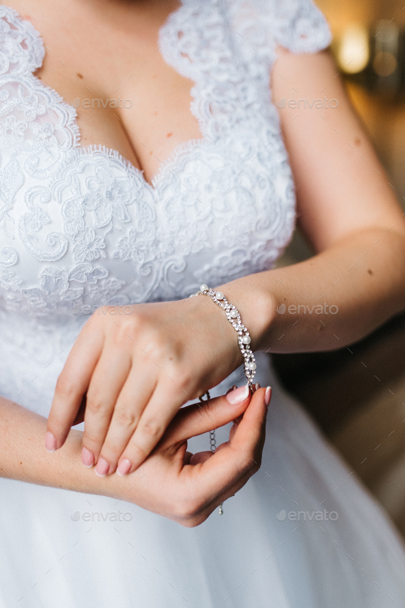 the bride wears a wedding bracelet on her left hand Stock Photo by