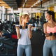 Beautiful fit women working out in gym to stay healthy Stock Photo by nd3000