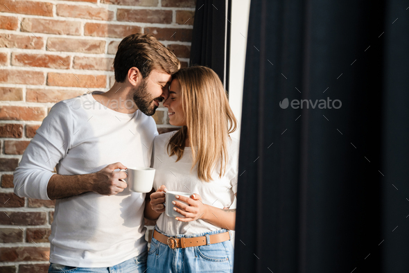 Happy young attractive couple having coffee