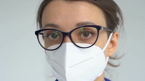 Female Doctor is Putting Off Protective Blue Gloves Isolated on White Background After Some Medical alt