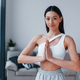 Does yoga exercises. Young woman with slim body shape in sportswear have  fitness day indoors at home Stock Photo by mstandret